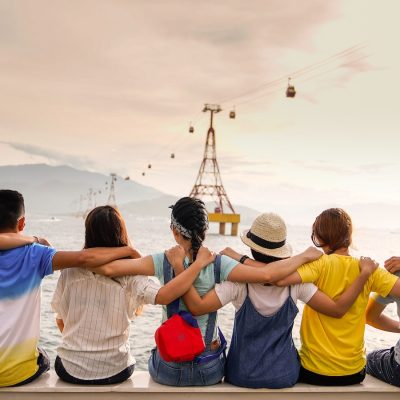 Photo by Duy Pham people holding shoulders sitting on wall